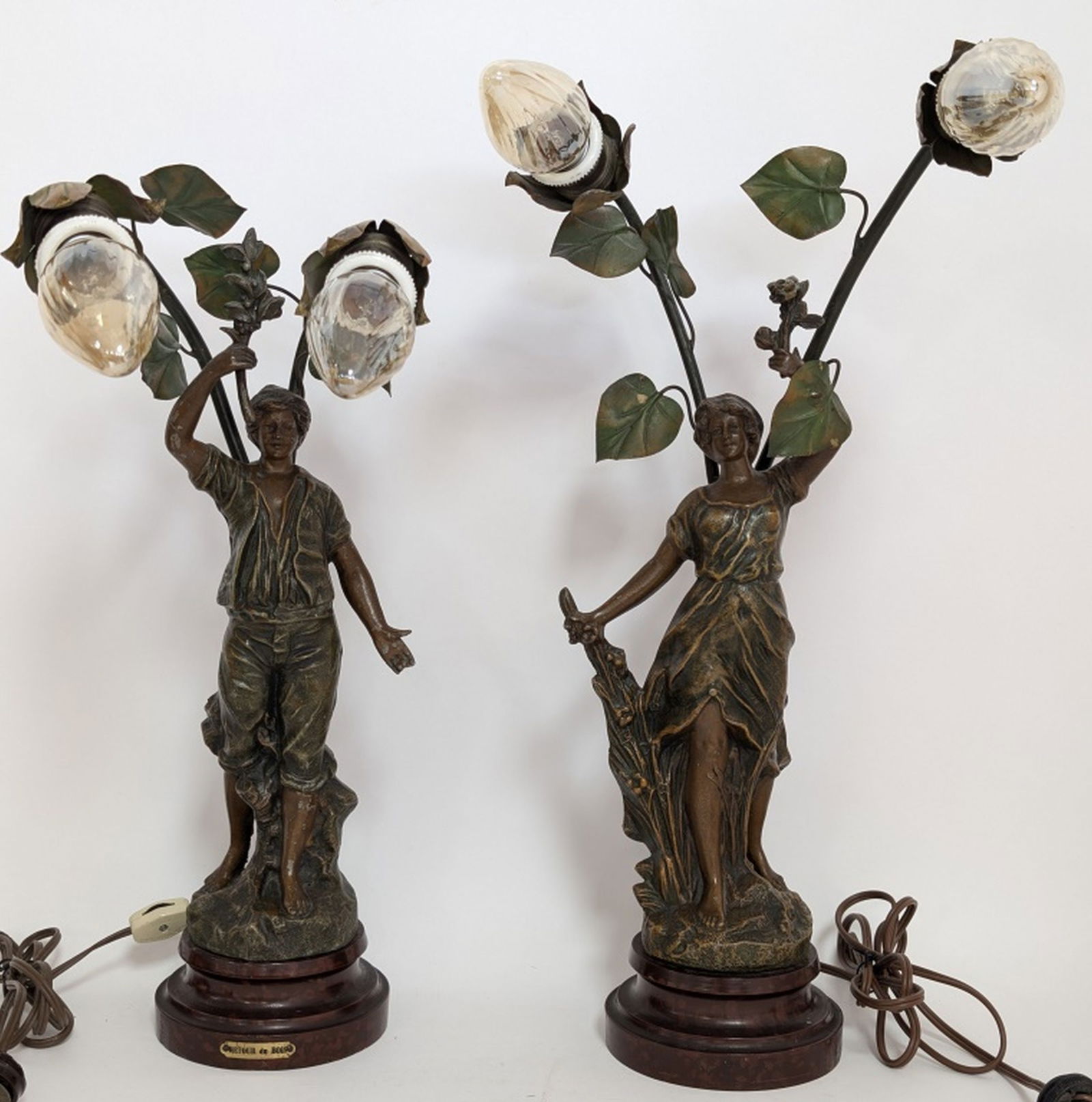 Pair- After Auguste Moreau Figural Spelter Lamps: Gorgeous antique cast metal figural lamps after Auguste Moreau. Circa 1910. Just beautiful. Both in working condition. 20H x 11W 6D". Normal antique wear and patina. Be sure and view all photos for co