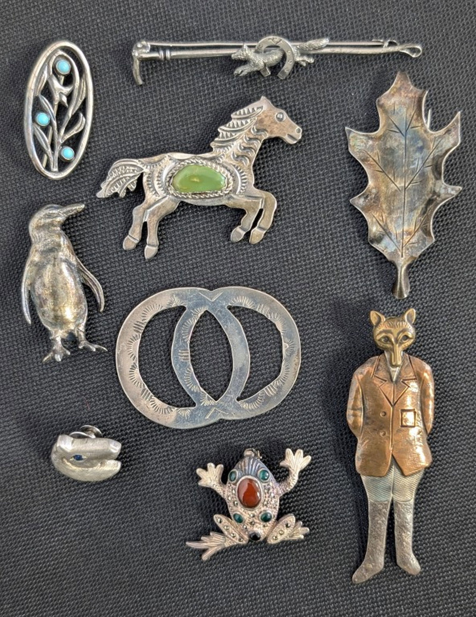 9- Sterling Silver Jewelry Pieces, 64.5 grams: Collection of Nine Sterling Silver Brooches, Pins, and Jewelry Articles, Including Native American, Animal, and Figural Designs. Charming and eclectic collection of nine sterling silver jewelry pieces