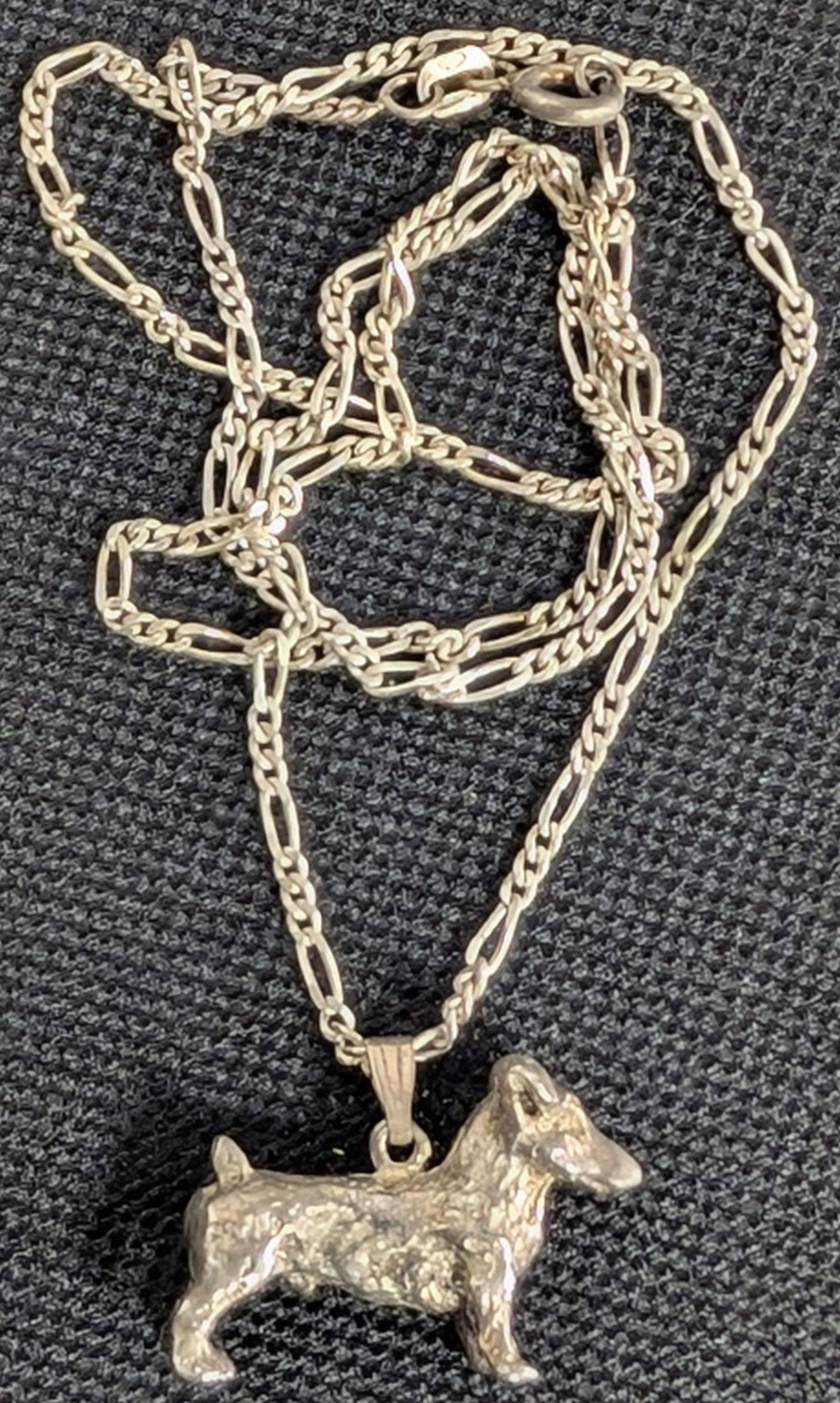 Sterling Silver Dachshund Pendant Necklace: Weight: 8.3 grams total. Necklace Length: Approximately 18 inches. Pendant Size: Approximately 7/8 x 1 inch. Charming sterling silver necklace featuring a three-dimensional Dachshund dog pendant suspe
