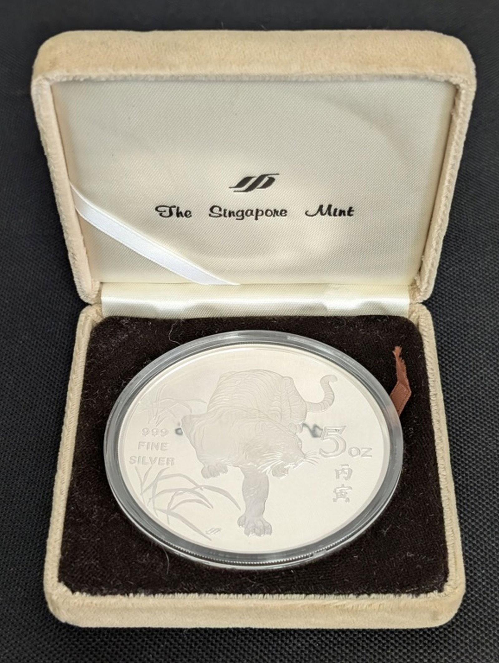 1986 5 Oz. Fine Silver Year of the Tiger Medal: 1986 Singapore Mint 5 Ounce .999 Fine Silver Year of the Tiger Medal. Struck by The Singapore Mint in 1986, this impressive five ounce .999 fine silver medal features a bold, high-relief depiction of 