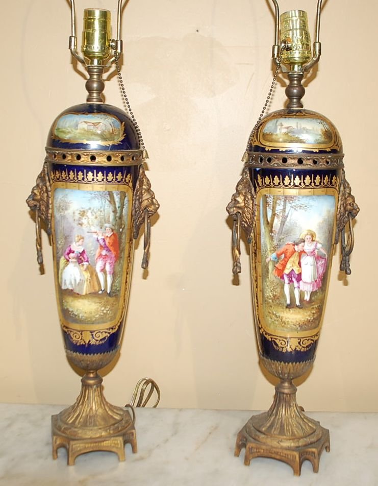 PAIR OF PORTRAIT PORCELAIN VASES: FROM THE GARRARD ESTATE, CHANGED TO TABLE LAMPS, YEARS AGO, PORTRAIT AND SCENIC DECORATION, LION RING PULLS, GILT DECORATION ON METAL, 7" DIAMETER, 17"TALL, PLUS LAMP HARPS