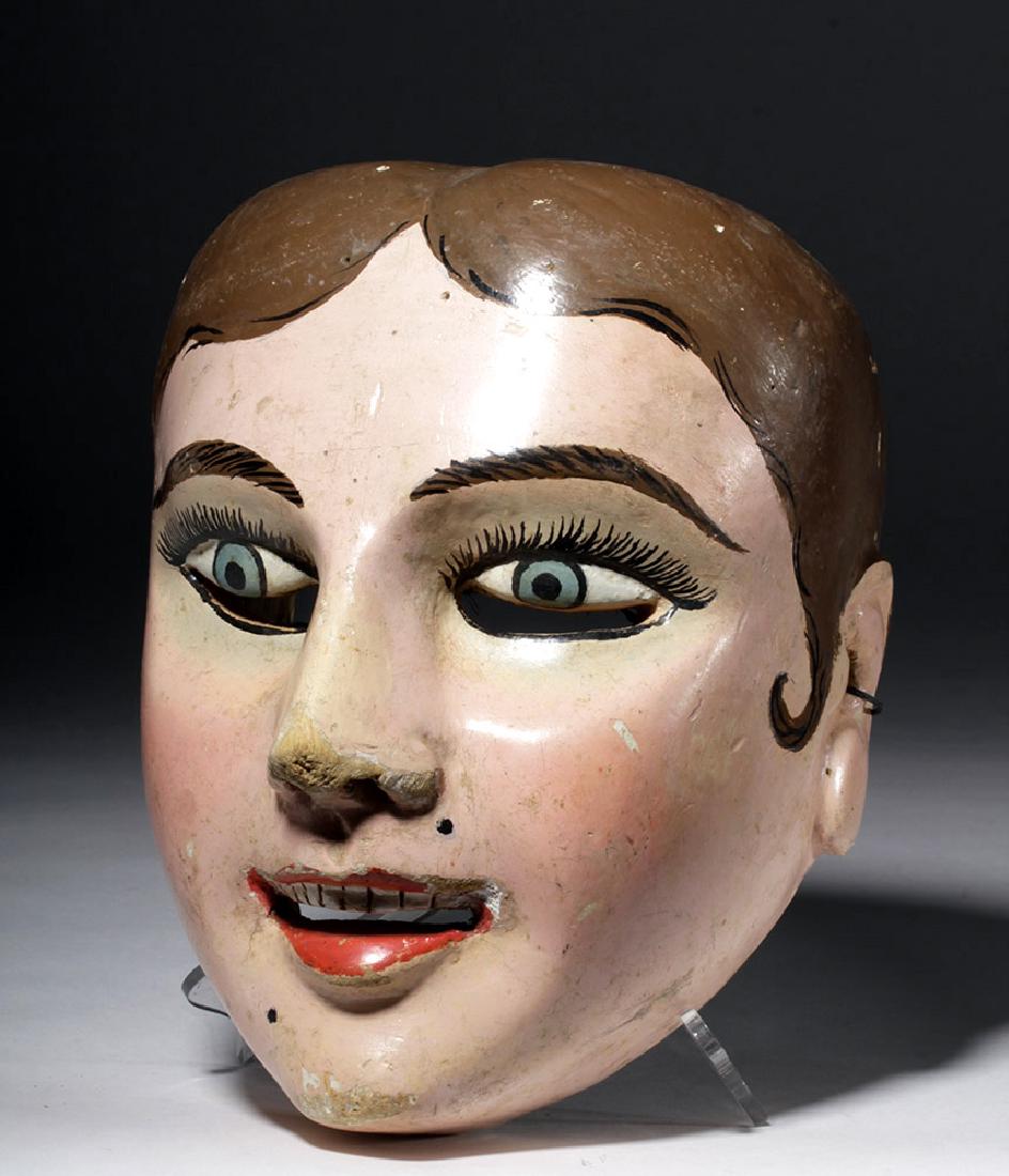 20th C. Guatemalan Painted Wood Festival Mask: Central America, Guatemala, 20th century CE. A huge wooden mask, painted realistically, showing a pale-complexioned person with blue eyes and straight brown hair. Slits under the eyes provide vision f