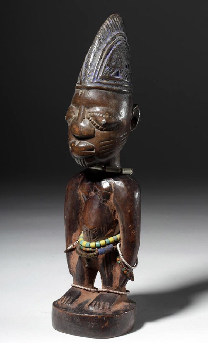 Early 20th C. African Ibeji Male Twin Wood Figure: West Africa, Nigeria, Yoruba peoples, ca. early 20th century CE. A male Ere Ibeji twin figure representing a deceased twin, hand carved from a single piece of wood, standing with his hands to his thig