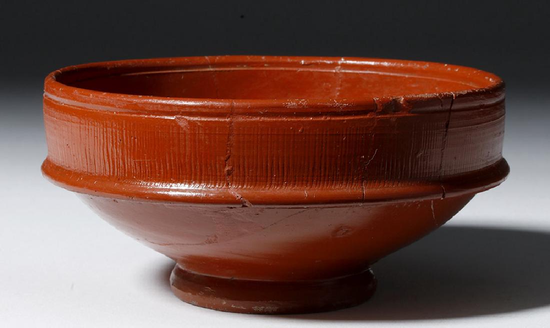 Gorgeous Roman Arretine Terra Sigilata Cup: Rome, Imperial Period, ca. 15 BCE to 30 CE. A beautifully made redware pottery cup, in the Arretine (Red Gloss) style, first produced in Arretium (Arezzo), Italy. These objects were made to have a hig