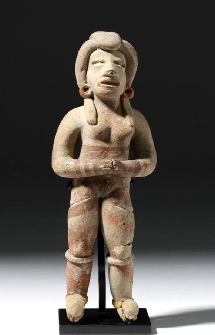 Very Early Tlatilco Pottery Standing Female: Pre-Columbian, Valley of Mexico, Tlatilco, ca. 800 BCE. A fantastic ceramic standing woman with hands clasped in front of her stomach. Her legs are long and her body slender; her coiffure and face are