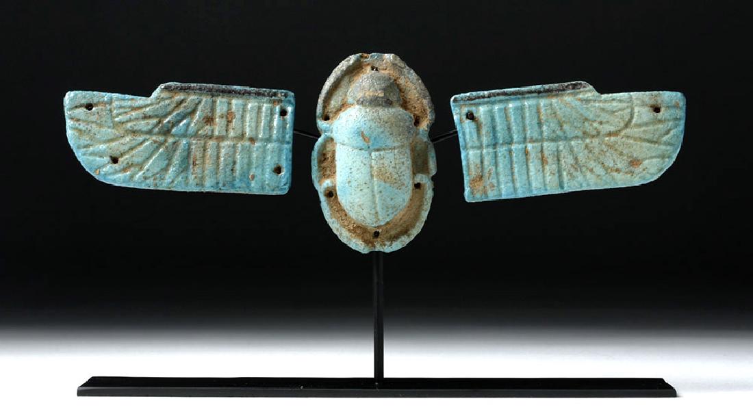 Egyptian Winged Scarab Faience Pectoral: Egypt, Ptolemaic Period, ca. 3rd to 1st century BCE. An ornate, turquoise blue faience winged scarab, molded separately in three parts, the wings and scarab finely modeled and highly detailed. All are