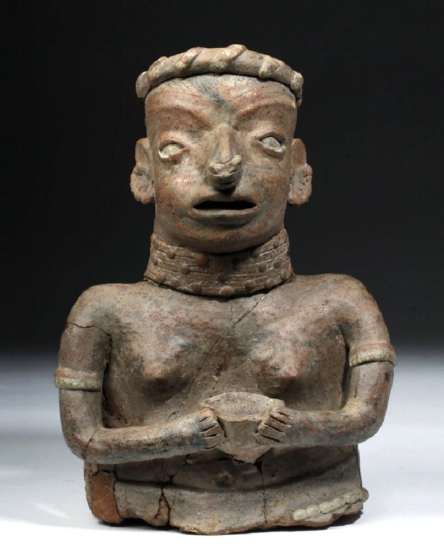 Enormous Nayarit Pottery Female Torso: Pre-Columbian, West Mexico, Nayarit, Ixtlan del Rio, ca 300 BCE to 300 CE. A hand-built polychrome terracotta figure depicting a female figure from the waist up holding a pottery bowl in her hands, al