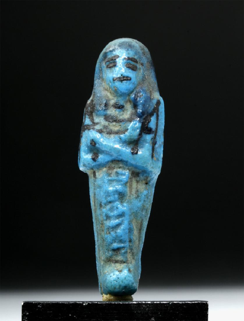 Egyptian Cobalt Blue Faience Ushabti - Rare Size!: Egypt, Third Intermediate Period, ca. 1070 to 712 BCE. A stunning miniature deep blue faience mummiform ushabti with molded hieroglyphs on its lower body and black-painted details on its head, back, a