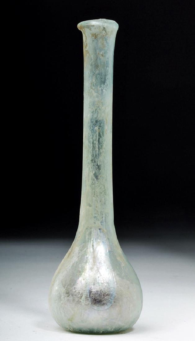 Roman Blue-Green Glass Vessel w/ Long Neck: **First Time At Auction**Roman Empire, Imperial Period, ca. 1st to 4th century CE. This attractive blue-green translucent vessel features a slightly concaved bottom with a smooth pontil, a small and b