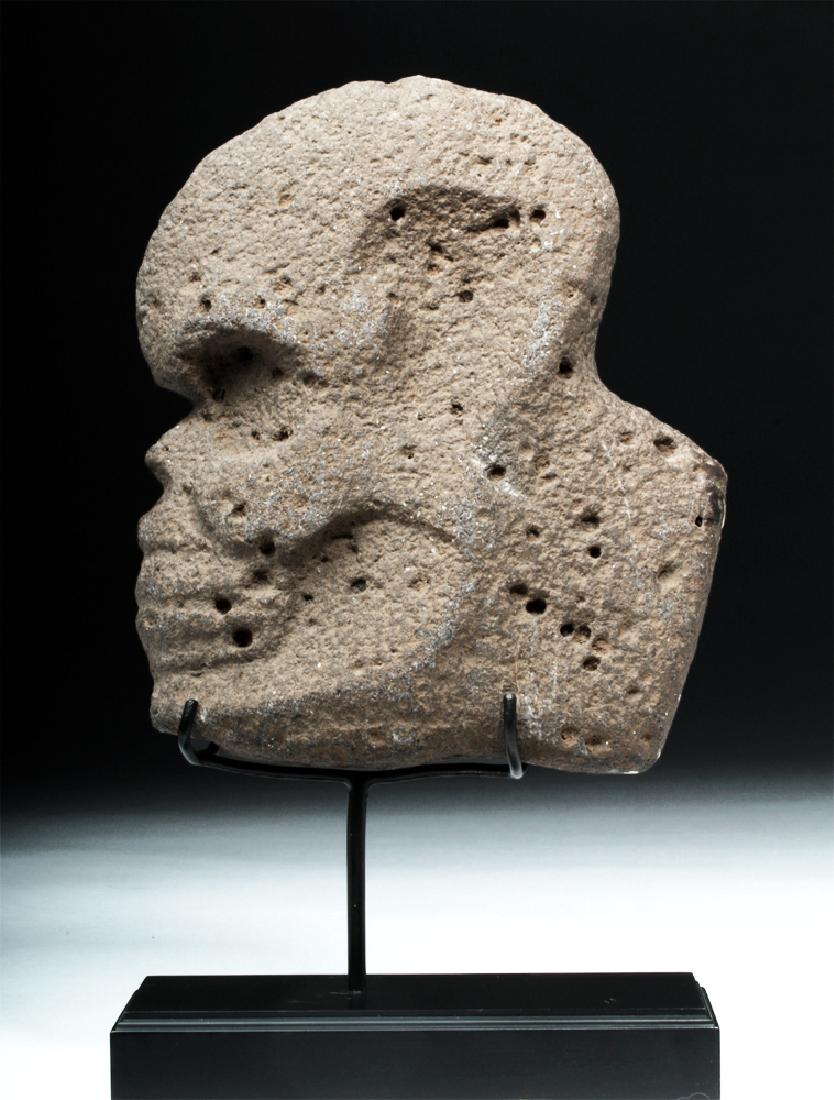 Veracruz Stone Hacha in Human Skull Form: Pre-Columbian, Mexico, Vera Cruz/Veracruz, ca. 700 to 900 CE. Carved on both sides, from a piece of volcanic stone of taupe hues, a ceremonial hacha depicting a human skull in profile, of an overall f