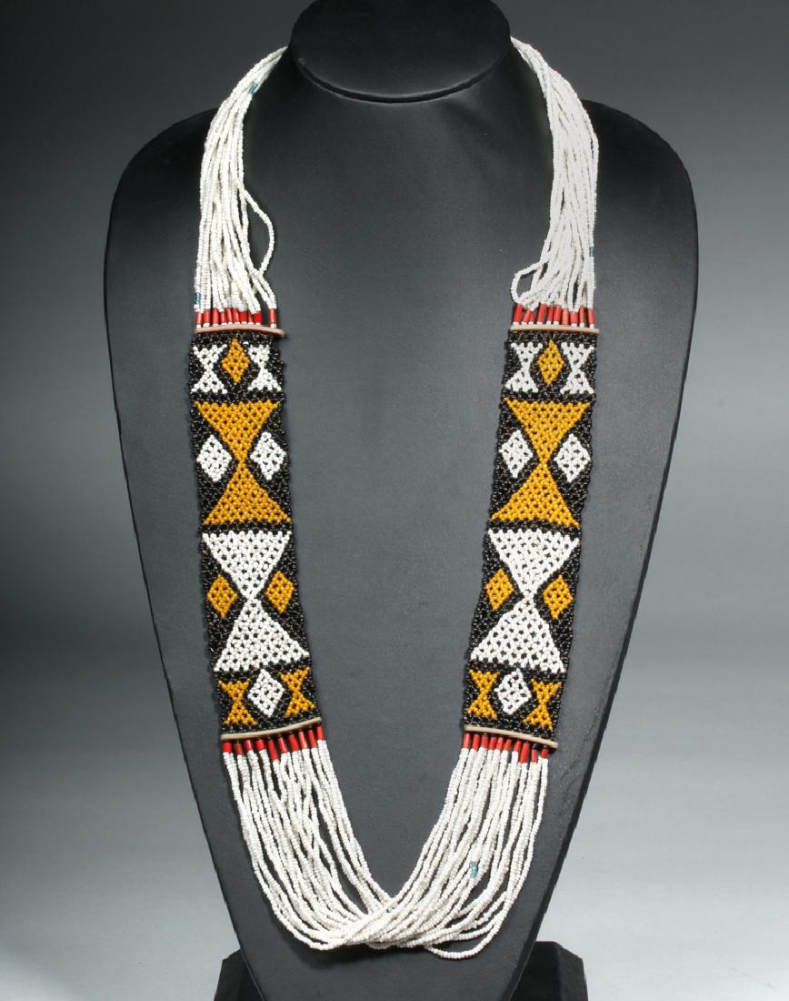 19th C. Indian Nagaland Glass Bead Belt / Necklace: Central Asia, India, Naga peoples, ca. end of 19th to early 20th century CE. A stunning glass bead necklace or possibly a belt, made by the Naga culture composed of twenty strands of mostly white glas