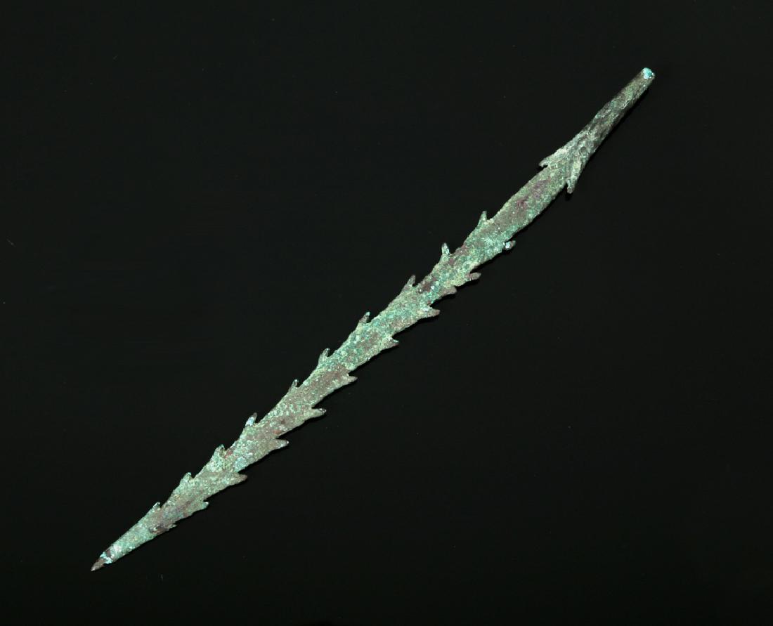 Indian Gangetic Copper Hoard Harpoon, ex-Piscopo: **First Time At Auction** India, Gangetic Basin, Copper Hoard Culture, ca. 1000 BCE. This is a delicate copper harpoon with a fine point and rows of sharp teeth down two sides. Copper artifacts like t