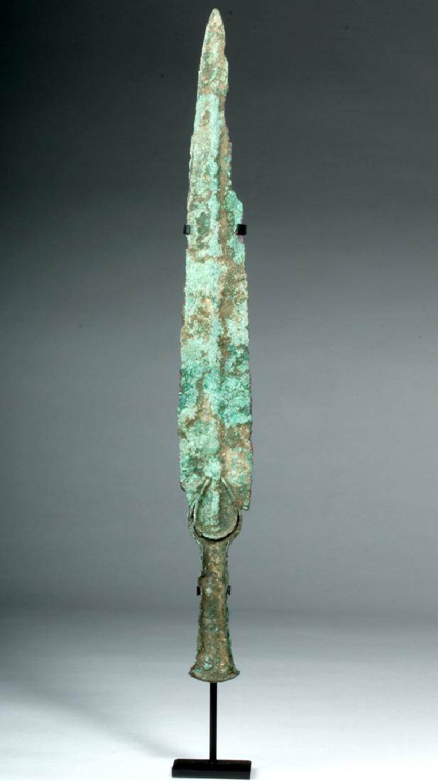 Ancient Bronze Marlik Dagger - Crescent Hilt: Ancient Near East, modern day northern Iran, Luristan, ca. 1500 to 1000 BCE. This is a heavy cast bronze dagger with a thick rib and a decorative arch at the top of the blade. The hilt would have had