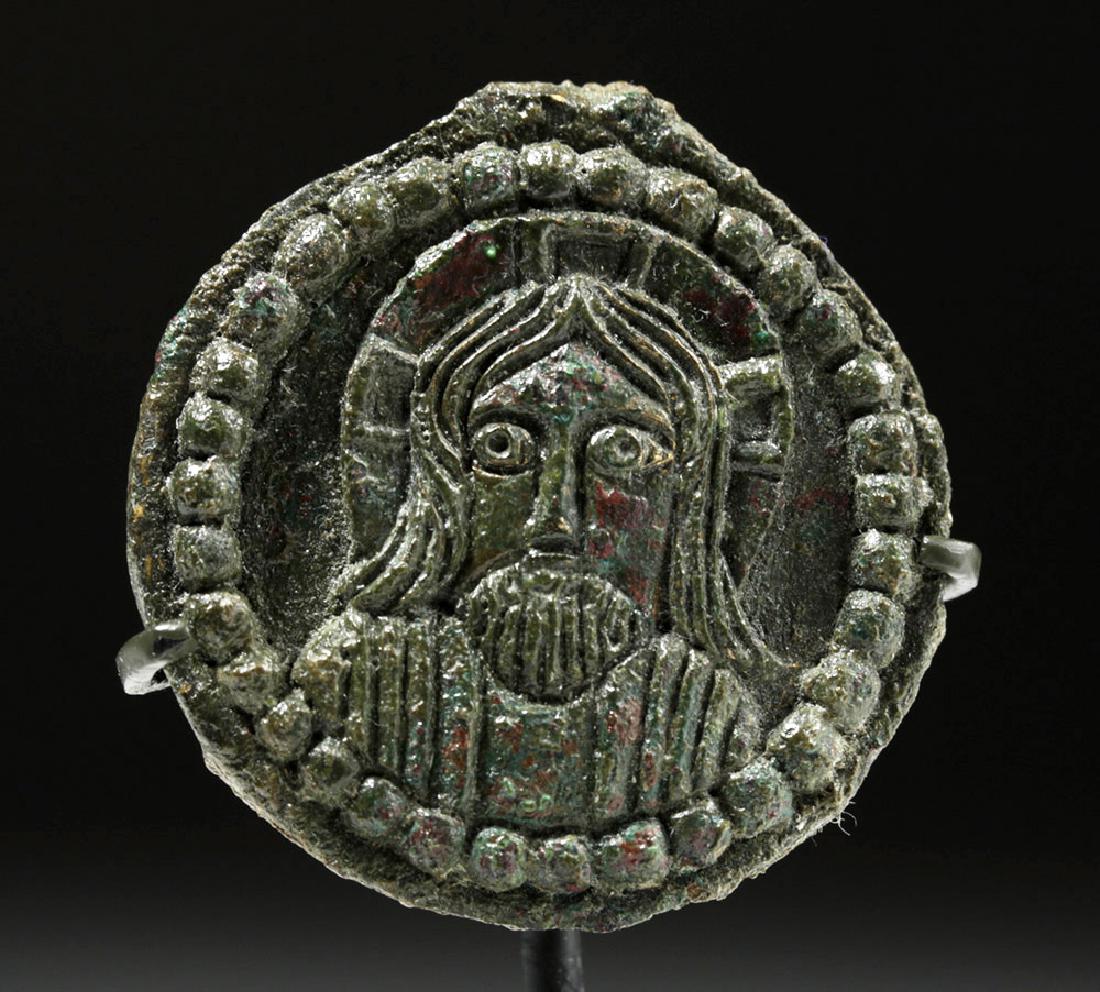 Rare Byzantine Bronze Roundel w/ Jesus: Byzantine Empire, ca. 8th to 12th century CE. A cast bronze roundel (orbiculi) portrait of the head and shoulders of Jesus Christ in low relief and surrounded by a border of raised circles. Behind his