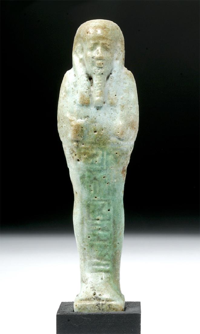 Egyptian Late Period Faience Ushabti: **Originally Listed at $250** Egypt, Late Period, Dynasty 27 - 30, ca. 525 to 343 BCE. Mummiform, faience with light blue/green glaze and details in relief, with tripartite wig and pleated divine bear