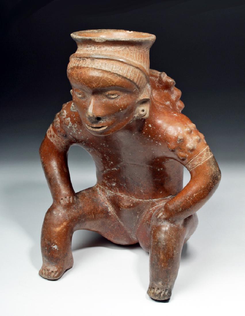 Important Colima Pihuamo Cargador Seated Figure: Pre-Columbian, West Mexico, Colima, Pihuamo style, ca. 300 BCE to 300 CE. A mesmerizing hand-built terracotta vessel depicting a male cargador - a carrier figure holding a burden, leaning forward with