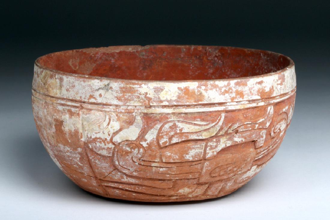 Mayan Carved Pottery Redware Bowl - Kukulkan: Pre-Columbian, southern Mexico and northern Central America, Mayan Territories, Late Classic period, ca. 550 to 900 CE. A round, steep-sided bowl, uniformly dark red colored, with a carved relief regi