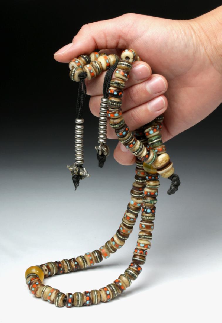 19th C. Tibetan Necklace - Prayer Beads: **First Time At Auction** Central Asia, Tibet, ca. 19th century CE. A lovely necklace comprised of 108 small carved bone beads and two large bone end-cap beads, all from a human skull, with inlaid sil