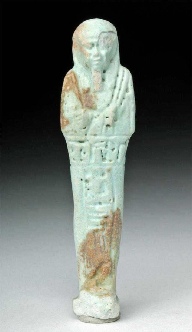 Egyptian Faience Ushabti w/ Hieroglyphs: Egypt, Late Dynastic Period, ca. 712 to 332 BCE. A faience ushabti (shabti) of an absolutely gorgeous, very pale blue color. The ushabti is very detailed, with hieroglyphs wrapped around the front of