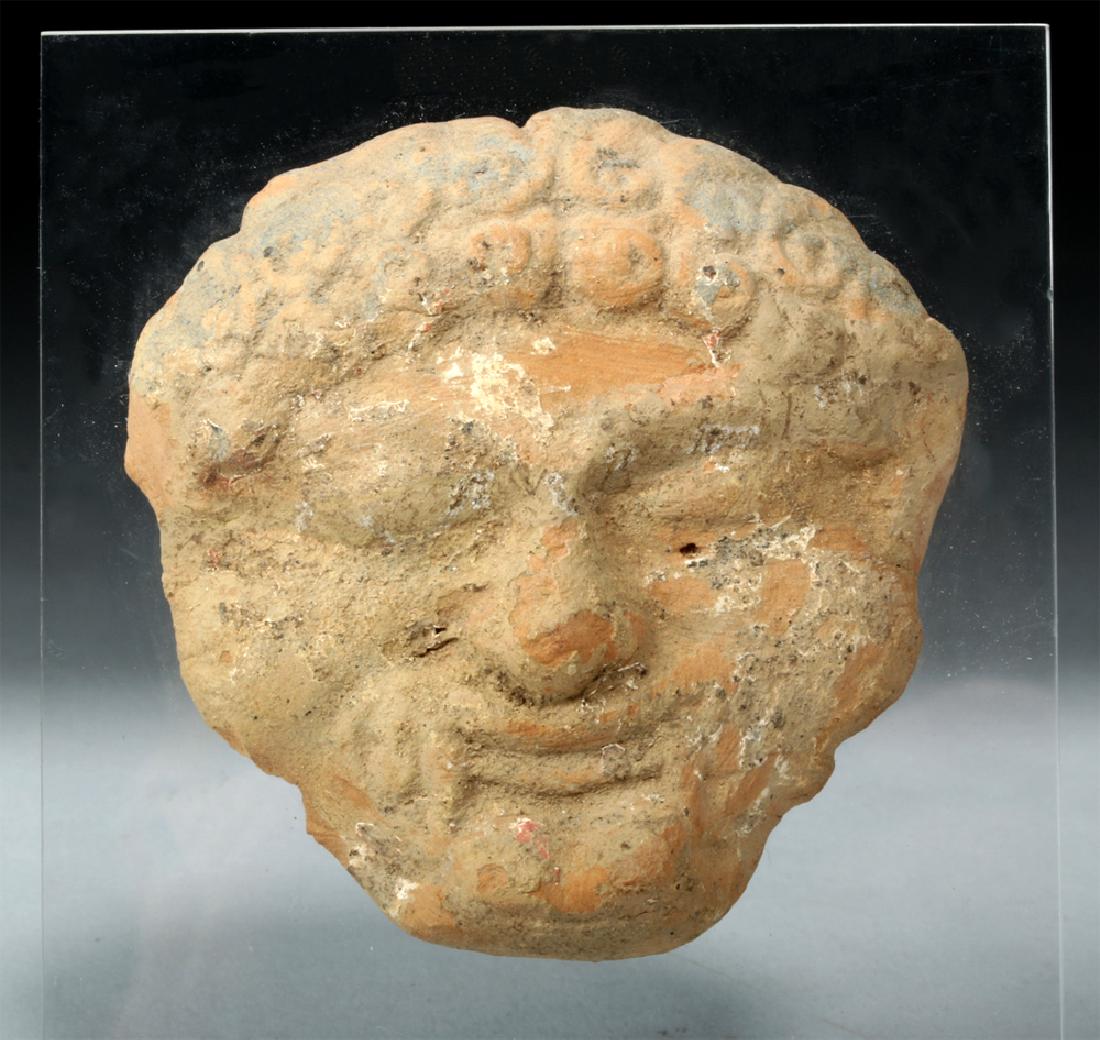 Western Greek Terracotta Applique of a Gorgon: **First Time At Auction** Ancient Greece, ca. 5th to 4th century BCE. A mold-made earthenware maskette depicting the head of a Gorgon - a frightening beast-like female creature seen as early as the da