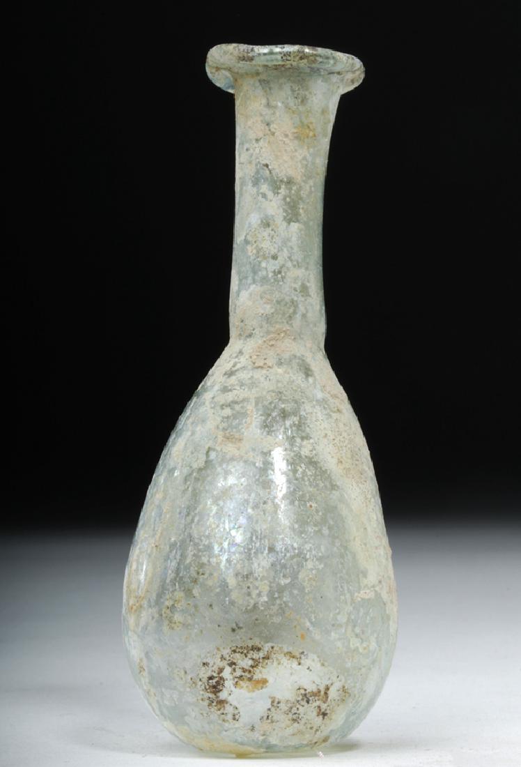 Petite Roman Green Glass Unguentarium: **Originally Listed At $100** Roman Empire, Imperial Period, ca. 2nd to 4th century CE. This diminutive and translucent green glass vessel features a slightly concaved base with a rough pontil, rounde