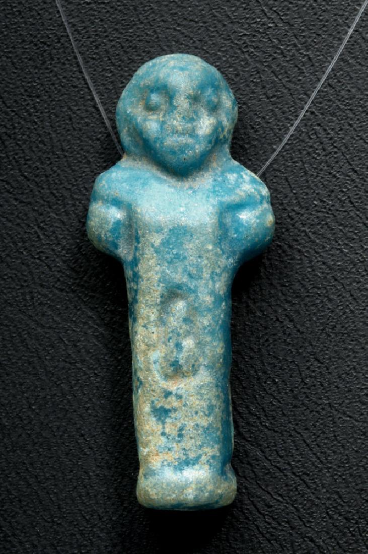Egyptian Faience Amulet - Nude Male Erect Phallus: Egypt, Greek / Roman period, ca. 300 to 0 BCE. A rare example of a bright blue faience amulet in the form of a male figure with simple facial features and arms and an incised, erect phallus. The figur