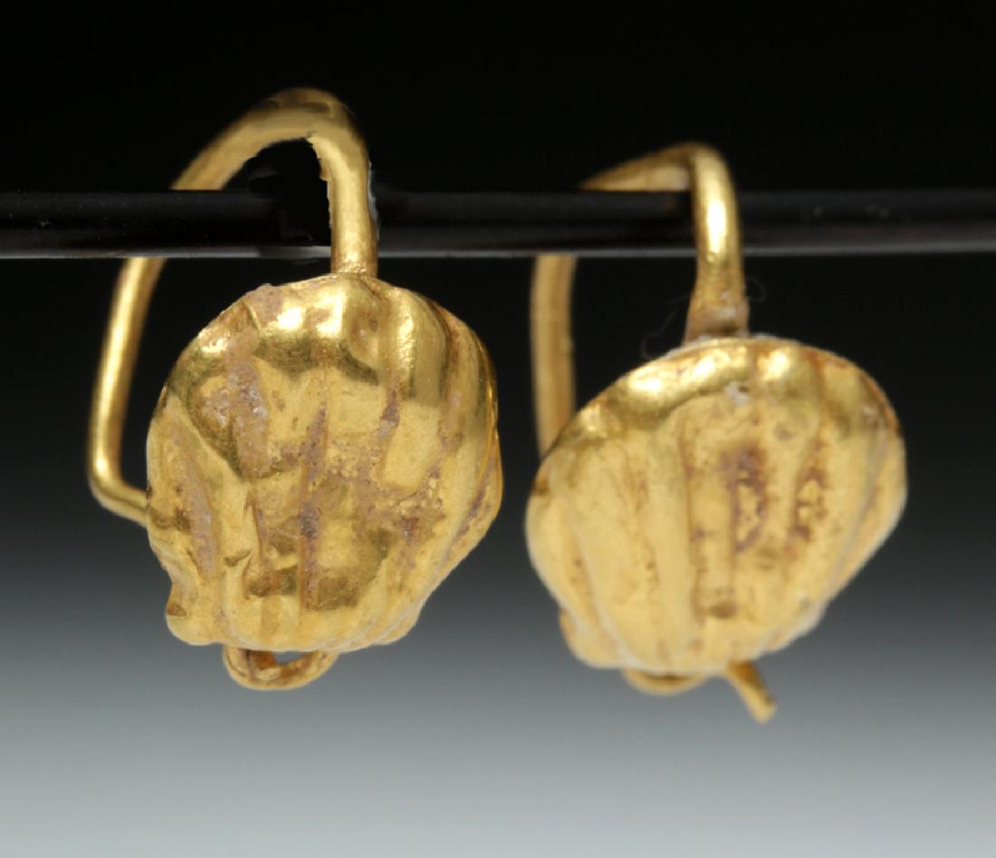 Delicate Roman 18K Gold Seashell Earrings - 2 g: Rome, Imperial Period, ca. 1st to 3rd century CE. A lovely pair of 18K gold hoop earrings, each one adorned with lovely seashell forms. The seashell was most associated Venus (Greek Aphrodite), the go