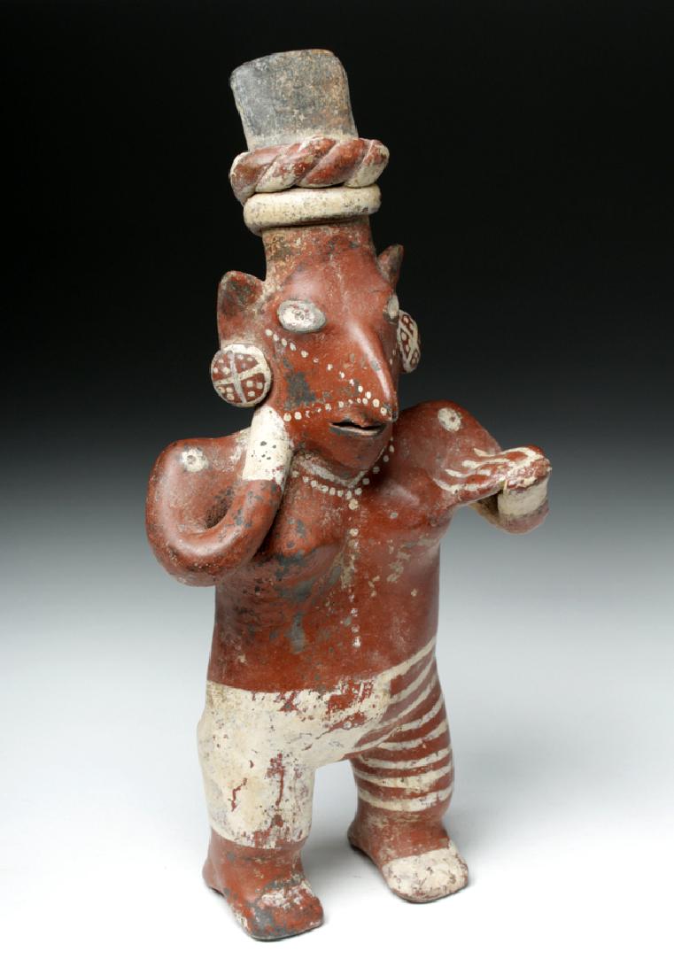 Superb Jalisco Sheepface Ceramic Figure: Pre-Columbian, West Mexico, Jalisco, ca. 300 BCE to 300 CE. Preserved in excellent condition, this is a classic "sheepface" figure of a standing woman. She is nude aside from painted decoration that g