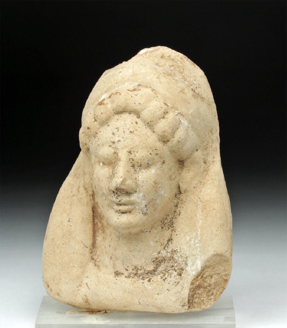 Western Greek Earthenware Protome of Goddess: **First Time At Auction** Western Greece, Archaic Period, ca. 6th century BCE. A finely-detailed terracotta protome of a goddess with bulb-shaped locks of hair framing her visage and a large headdress
