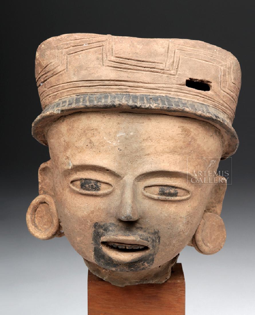 Vera Cruz Pottery Head of a Priest: Pre-Columbian, Gulf Coast Mexico, Vera Cruz, Remojadas, ca. 550 to 950 CE. A finely-detailed, hand-built terracotta effigy head from a larger figure. Meant to resemble a priest, this sizable visage bo
