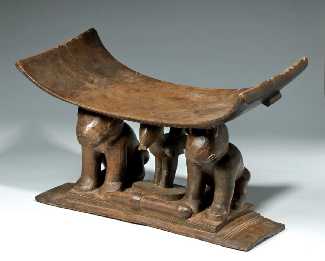 Fine Old Asante Wood Carved Stool - Ex M Simpson: Africa, Fante/Asante, ca. 20th century CE. A grand, hand-carved wooden ceremonial stool/bench with a rectangular base upon which stand zoomorphic figures sharing a plinth adorned with an incised diamo
