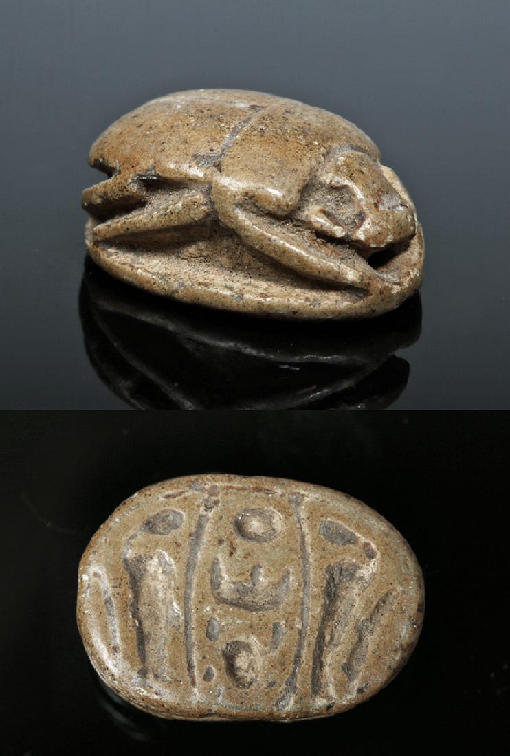Egyptian Steatite Royal Scarab for Thutmose III: **Originally Listed At $200** Egypt, New Kingdom, 18th Dynasty, ca. 1479 to 1425 BCE. A tan stone steatite beetle of a relatively naturalistic form, notched wing case, the base inscribed with Royal ca
