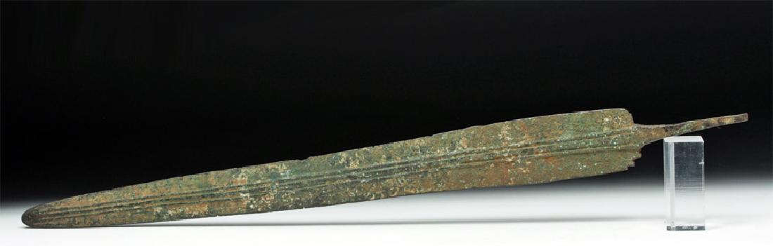 Large Central Asian Bronze Sword - Ex Piscopo: **Originally Listed At $200** Central Asia, ca. 1st millennium BCE. A long, flat, cast bronze sword with three slightly raised midribs running down its center line. A short, narrow tang rises from the