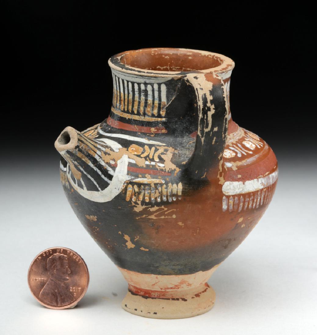 Lovely Greek Gnathian Near-Miniature Baby Feeder: Classical World, Magna Graecia, Southern Italy, Gnathian, ca. 340 to 320 BCE. A finely made ceramic bottle feeder for an infant, with a looped handle joining upper neck to shoulder, a pronounced round