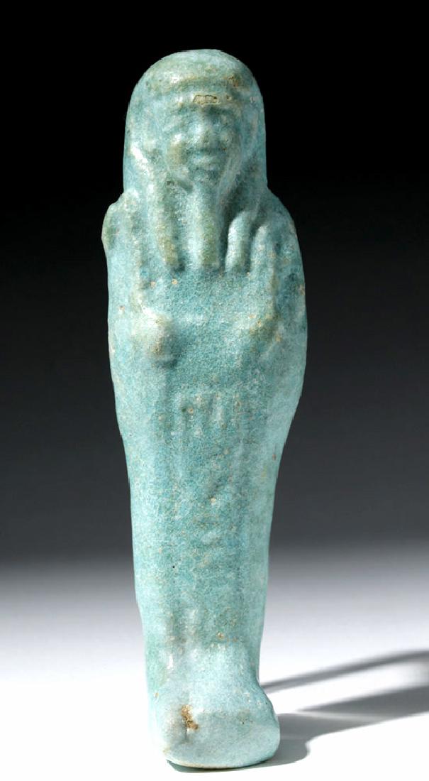 Lovely Egyptian Robin's Egg Blue Faience Ushabti: Egypt, Late Dynastic Period, 26th Dynasty, ca. 664 to 525 BCE. Robin's egg blue faience ushabti, holding crook and flail held in crossed hands, line of hieroglyphs down front. A lovely example! Size: