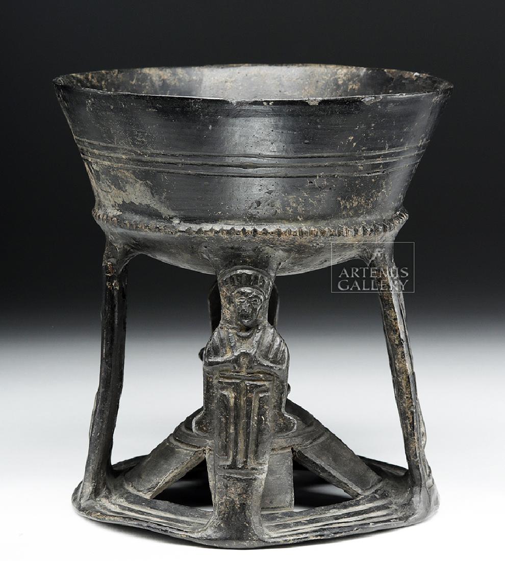 Etruscan Bucchero Chalice, ex-Royal Athena: Classical World, Etruria, ca. early 6th century CE. A stunning chalice with a deep, slightly concave bowl and flaring, round, openwork foot with a narrow leg and four long, flattened strips down from 
