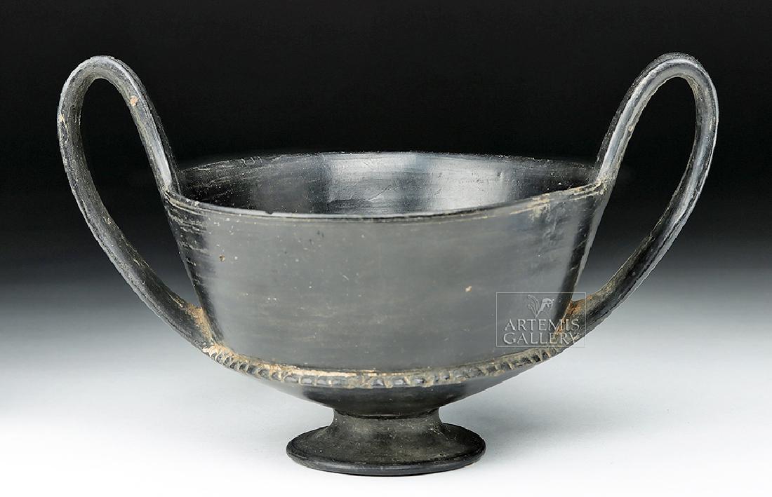 Etruscan Bucchero Pottery Kantharos: Classical World, Italy, Etruscan culture, ca. 768 to 264 BCE. A ceramic kantharos, a deep vessel with distinctive high handles, meant for consuming wine. This example has a flanged border between the 
