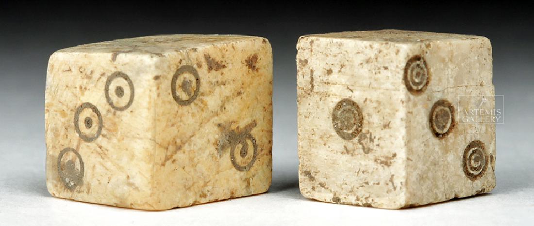 Pair of Roman Imperial Bone Dice: Roman, Imperial Period, ca. 1st to 3rd century CE. A fine pair of hand-shaped dice, made from the bones of a cow or other ungulate mammal. Each die has six planar sides, each containing a number of co