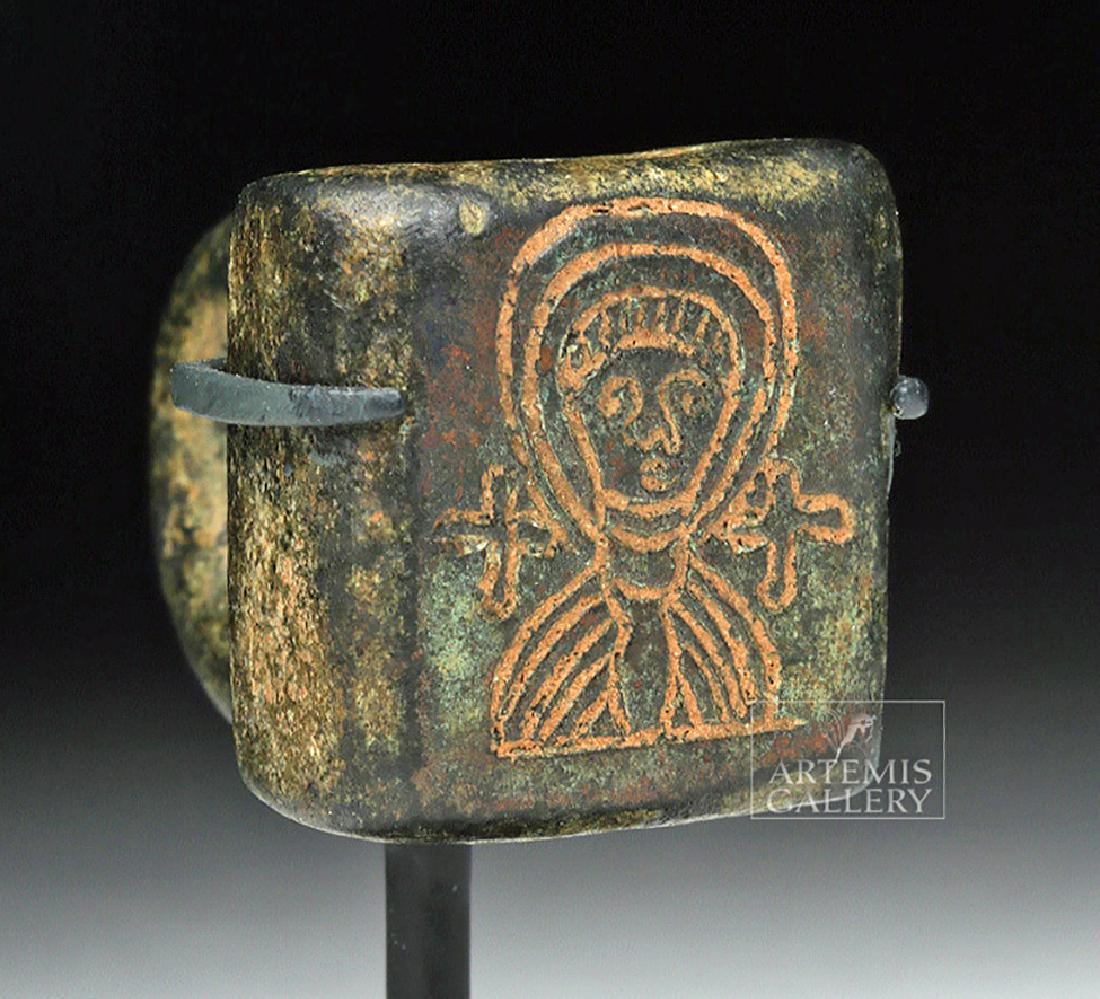 Miniature Byzantine Bronze Stamp w/ Saintly Image: Ancient Near East, Holy Land, Byzantine Empire, ca. 7th to 10th century CE. A petite cast bronze ring stamp likely meant to hang from a key ring or a necklace. The body is thick and square, the stamp 