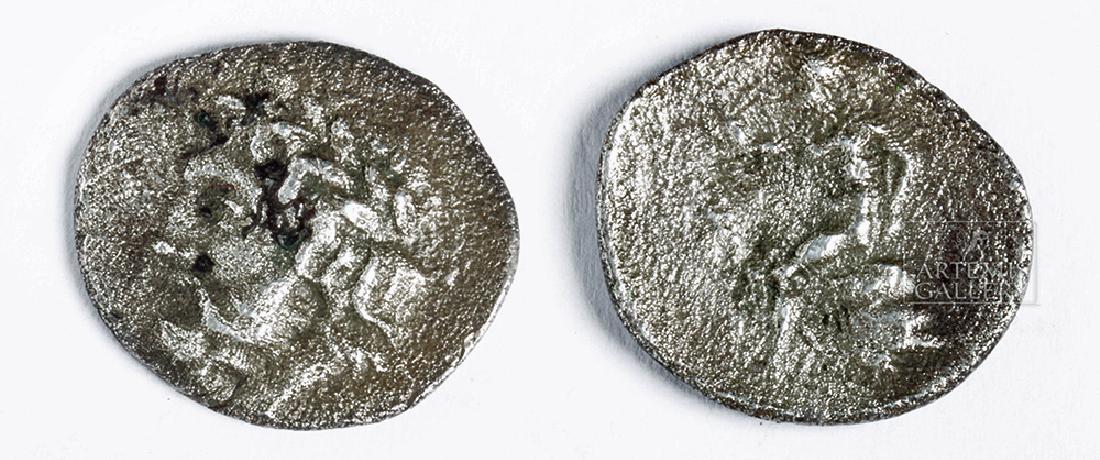 Small Greek Silver Coin from Megalopolis - Arcardia: **First Time At Auction** Arcadia, Megalopolis, for Arcadian League, 280 BCE to 234 BCE. AR triobol 1.9 grams. OBVERSE: Laureate head of Zeus to left. REVERSE: Youthful Pan, nude, seated l. on rock.