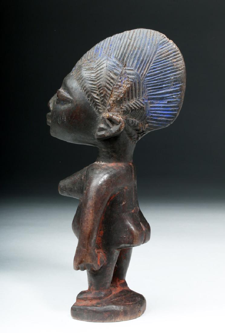 African Yoruba Ere-Ibeji Wooden Female Figure: **Originally Listed At $125** West Africa, Nigeria, Yoruba peoples, ca. early 20th century CE. A tall wooden Ere Ibeji figure standing upon an integral circular base, hand-carved to represent a deceas