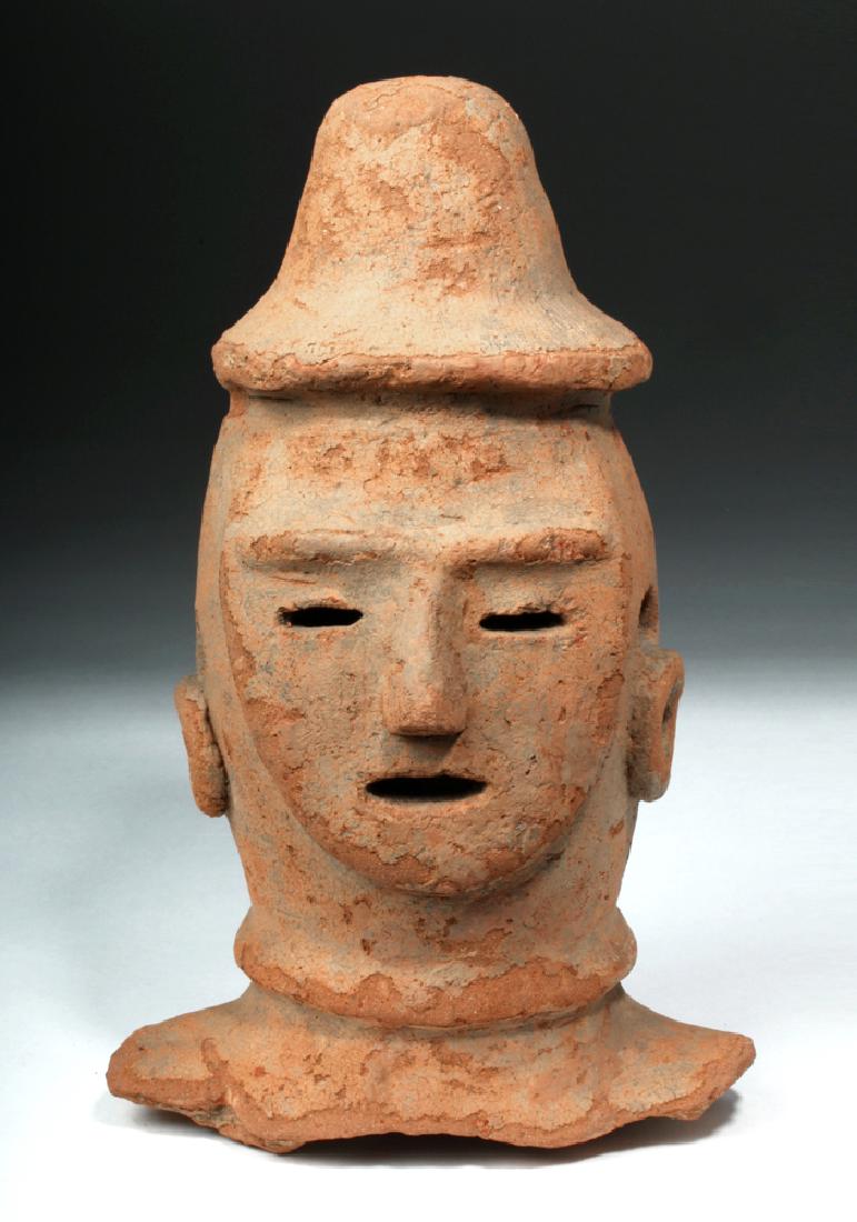 Japanese Kofun Haniwa Pottery Head - TL Tested: East Asia, Japan, Kofun Period, ca. 450 to 600 CE. A fantastic and rare ceramic head with mask-like human features and a conical hat. His eyes and mouth are open, narrow slits, while his nose and eyeb