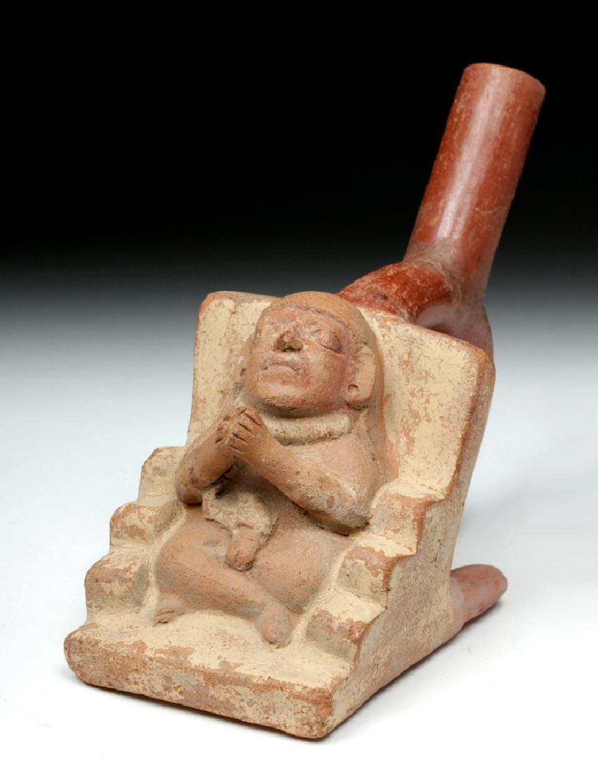 Rare Moche Erotic Pottery Stirrup Vessel: Pre-Columbian, Peru, Moche III to Moche IV (Classic Period), ca. 450 to 650 CE. A fascinating and gruesome mold-made ceramic figural vessel in the form of a seated man with a snake wrapped around his 