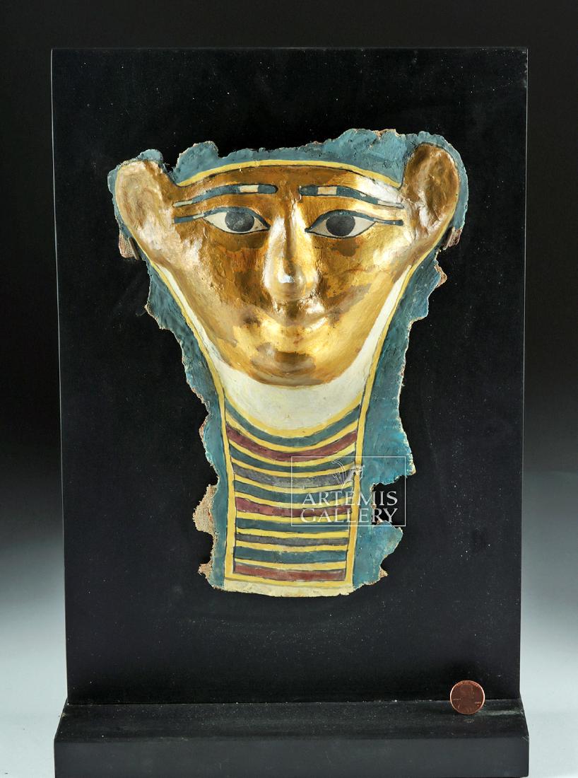 Egyptian Ptolemaic Gilded Cartonnage Sarcophagus Mask: Ancient Egypt, Ptolemaic Period, ca. 332 to 30 BCE. A fabulous gilded cartonnage sarcophagus mask, displaying quintessential Egyptian beauty, made from layers of plaster-covered linen and painted with
