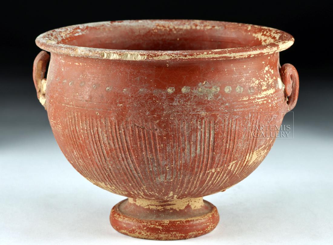 Early Roman Redware Vessel: **First Time At Auction** Roman, Republican period, ca. late first millennium BCE. A pretty vessel with a bulbous, deep body and a diminutive round foot. The vessel is painted a deep red, and has inci