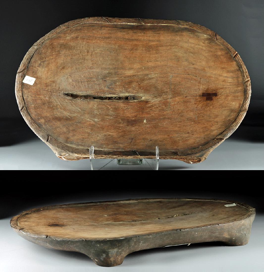 Massive 20th C. Hawaiian Koa Poi Platter: Oceania / Polynesia, Hawaiian Islands, ca. early 20th century CE. A massive koa wood platter with a shallow bowl and a carved border that looks like thick, twisted rope or branches. The platter stands
