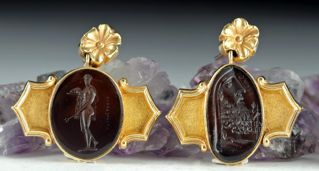 Victorian 19K Gold Earrings w/ Glass Intaglios (pr): Europe, United Kingdom, Victorian period, ca. 19th century CE. A pair of unique 19 karat gold earrings, each with a russet glass intaglio. One intaglio features a youthful, nude male figure, classical