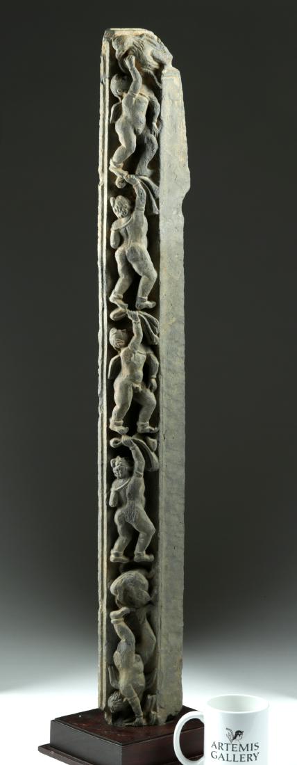 Tall & Rare Gandharan Schist Frieze: Central Asia, Pakistan, India, and Afghanistan, Gandharan Empire, ca. 1st to 3rd century CE. A delightful panel carved from dark gray schist showing five figures, nude save a cloak over their shoulder