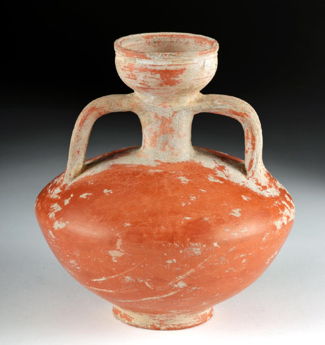 Roman Redware Flagon - Excellent Preservation: Roman, Imperial Period, ca. 1st to 3rd century CE. An elegant and well-preserved wheel-thrown red-slip flagon with a thick base, a wide flaring body with a rolled shoulder, a short, tubular neck with