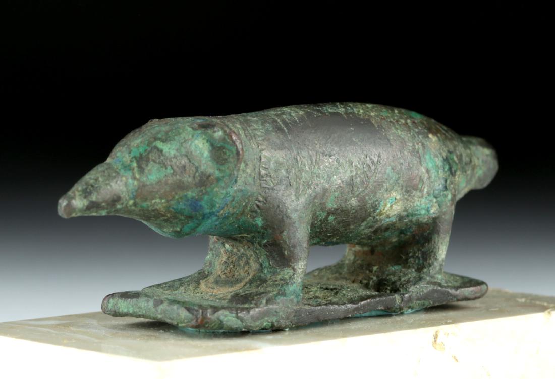Delightful Egyptian Bronze Shrew (from Sarcophagus): Ancient Egypt, Late Period, ca. 712 to 300 BCE. A charming cast bronze shrew - bigger than the actual animal it is based upon - that was a common adornment of a sarcophagus. The adult Egyptian pygmy s